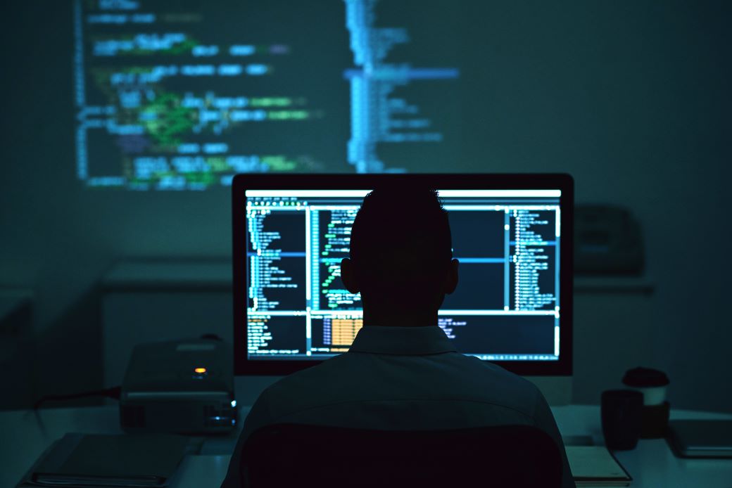 Software engineers collaborating on code in a modern office